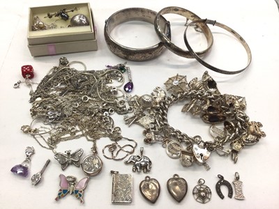 Lot 1032 - Silver charm bracelet, three silver bangles, insect bar brooch and a quantity of silver and white metal pendants and chains