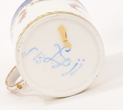 Lot 59 - Sèvres cup and saucer, polychrome decorated with floral swags on a blue ground, initial 'C' to the front of the cup, inscribed marks to base, possible date mark of 1786, the saucer 12cm diameter
