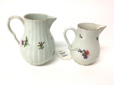 Lot 64 - Two 18th century Worcester sparrow beak cream jugs, one with a fluted body, both polychrome decorated with floral sprays, 8.75cm and 10.5cm high