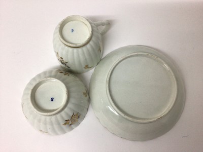 Lot 66 - Caughley trio, circa 1790, of fluted form, decorated in underglaze blue and gilt with floral sprays, 'S' marks, the saucer 13.5cm diameter