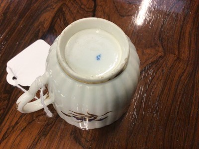 Lot 66 - Caughley trio, circa 1790, of fluted form, decorated in underglaze blue and gilt with floral sprays, 'S' marks, the saucer 13.5cm diameter