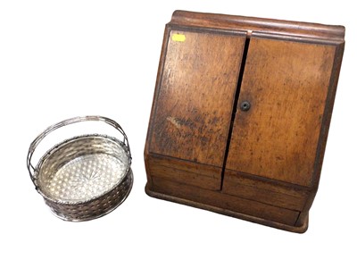 Lot 357 - Wooden table top stationery cabinet, together with a silver plated basket with glass liner