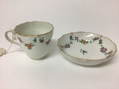 Lot 70 - Chelsea Derby coffee cup and sauce, circa 1774, of ogee shape and painted with swags of flowers, with gilt dentil rim, gold D and anchor mark to base, the saucer 12cm diameter