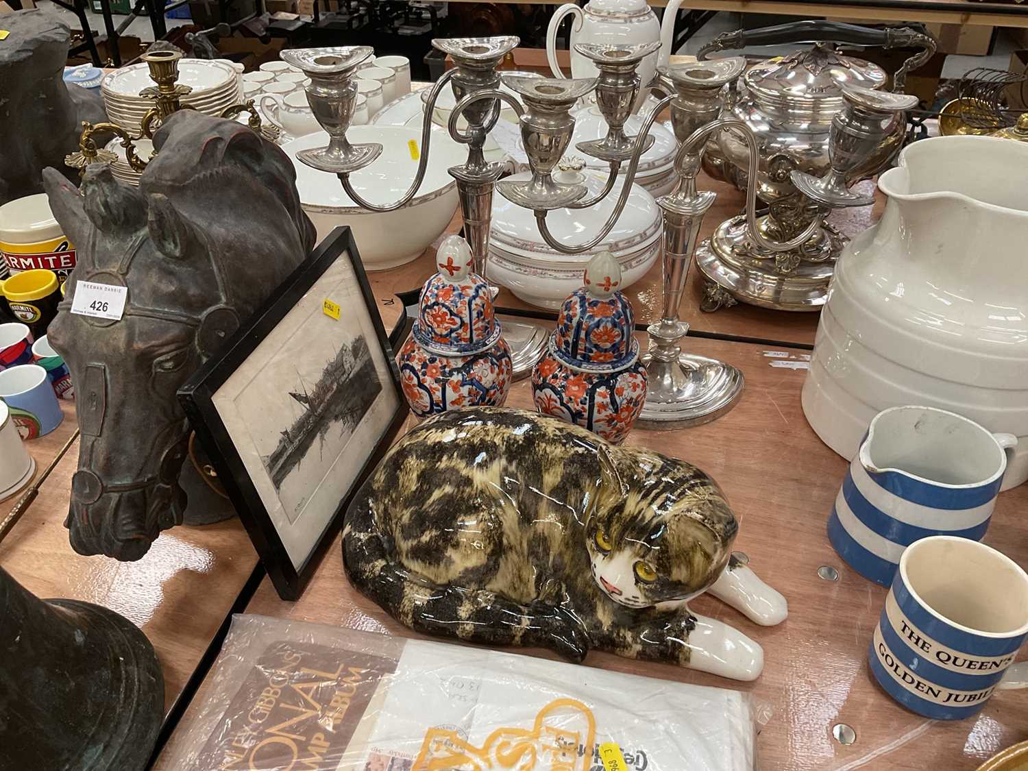 Lot 428 - Pair of Japanese Imari vases and covers, a ceramic model of a cat, a pair of silver plated candelabra, and a signed etching of St. Osyth by Morton Matthews