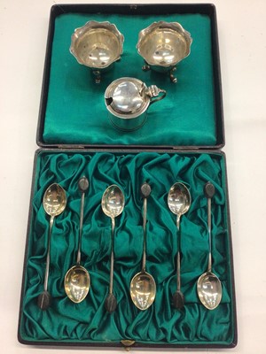 Lot 1042 - Set of six silver coffee bean spoons in fitted case, pair of silver salts and a silver mustard with blue glass liner