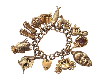 Lot 25 - 9ct gold charm bracelet with eleven 9ct gold novelty charms