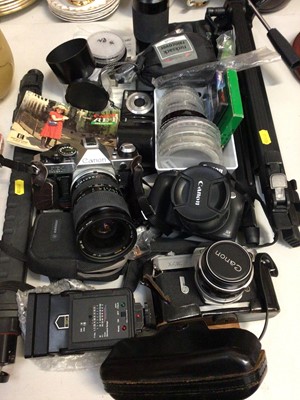 Lot 309 - Three vintage Canon cameras, Tamron Adaptall 2 for Canon lense, tripod and accessories