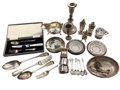 Lot 1083 - Group of silver to include a gravy boat, condiments, napkin rings, photograph frame, flatware, candlestick and other items