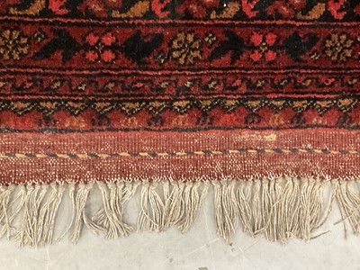 Lot 1430 - Large Eastern rug on red ground, previously purchased from Harrods