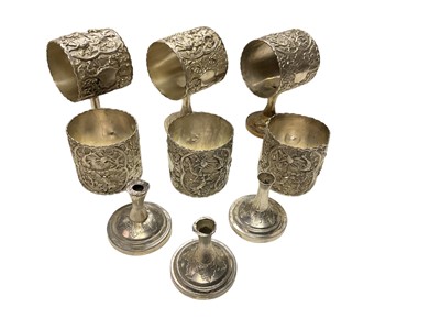 Lot 335 - Six Far Eastern white metal napkin rings on pedestal bases