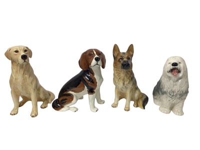 Lot 321 - Four Beswick fireside dog ornaments - Alsation 2410, Golden Labrador 2314, Old English Sheepdog 2232 and Beagle (no number)