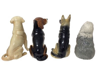 Lot 321 - Four Beswick fireside dog ornaments - Alsation 2410, Golden Labrador 2314, Old English Sheepdog 2232 and Beagle (no number)