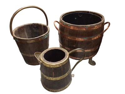 Lot 325 - Large copper bound wooden fire bucket with two handles and raised on three paw feet, together with two other fire buckets (3)