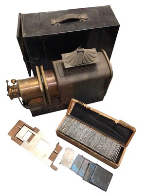 Lot 326 - Vintage magic lantern in case together with a box of glass slides depicting mostly landscape and seascape views