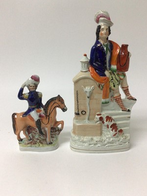 Lot 119 - Staffordshire pottery figure of a Highlander with a spaniel at a well, and another of a figure on horseback