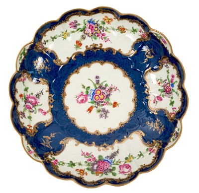 Lot 105 - Worcester junket dish, painted with flowers on a blue scale ground, circa 1770