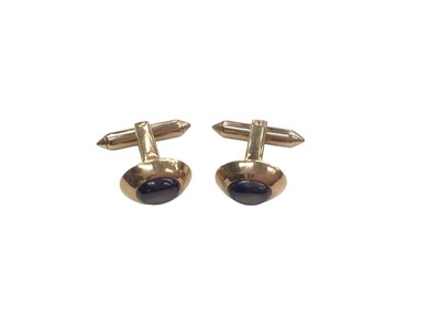 Lot 1021 - Pair of 18ct gold cufflinks, each oval panel set with a dark grey cabochon