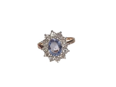 Lot 203 - Sapphire and diamond cluster ring with an oval mixed cut cornflower blue sapphire surrounded by twelve brilliant cut diamonds in 9ct gold setting