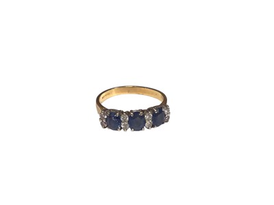 Lot 204 - Sapphire and diamond ring with three oval mixed cut blue sapphires interspaced by eight brilliant cut diamonds in claw setting on 18ct gold shank