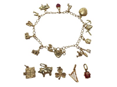 Lot 1036 - 9ct gold charm bracelet with various charms, some loose