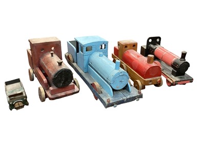 Lot 1551 - Three red painted wooden and one blue painted wood and metal home made trains, c1950s.  One homemade green painted wooden toy truck c1930s.