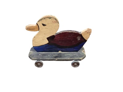 Lot 1560 - Homemade wooden toy duck on wheels, 9inches x 7inches, with original paint an alloy wheels, c1930s