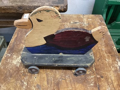 Lot 1560 - Homemade wooden toy duck on wheels, 9inches x 7inches, with original paint an alloy wheels, c1930s