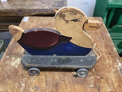 Lot 1560 - Homemade wooden toy duck on wheels, 9inches x 7inches, with original paint an alloy wheels, c1930s