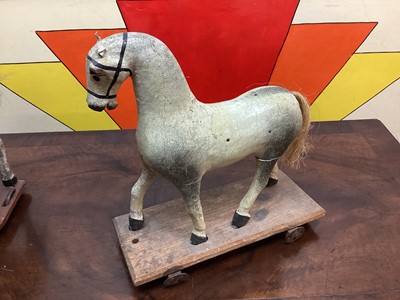 Lot 1577 - Three 19th century child's carved horses on wheeled bases