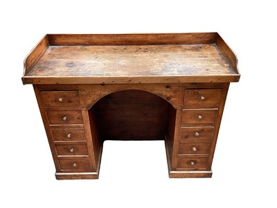 Lot 1606 - Early 19th century pine twin pedestal desk with galleried ash top and ten drawers, possibly estate built