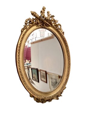 Lot 1382 - Louis XVI style oval giltwood and gesso mirror, late 19th/early 20th century