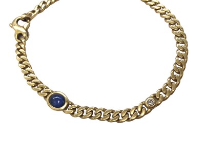 Lot 55 - 18ct gold curb link bracelet set with a cabochon blue sapphire and a brilliant cut diamond