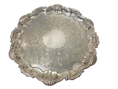 Lot 340 - Edwardian silver salver of circular form, with engraved centre and shell and scroll border, on three ball and claw feet (Sheffield 1907) Martin Hall. All at approximately 11ozs. 21.5cm across.