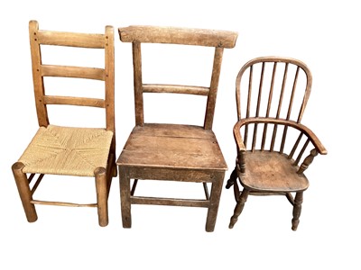 Lot 1769 - 19th century child's stick back chair, a caned ladder back chair and a primitive oak chair (3)