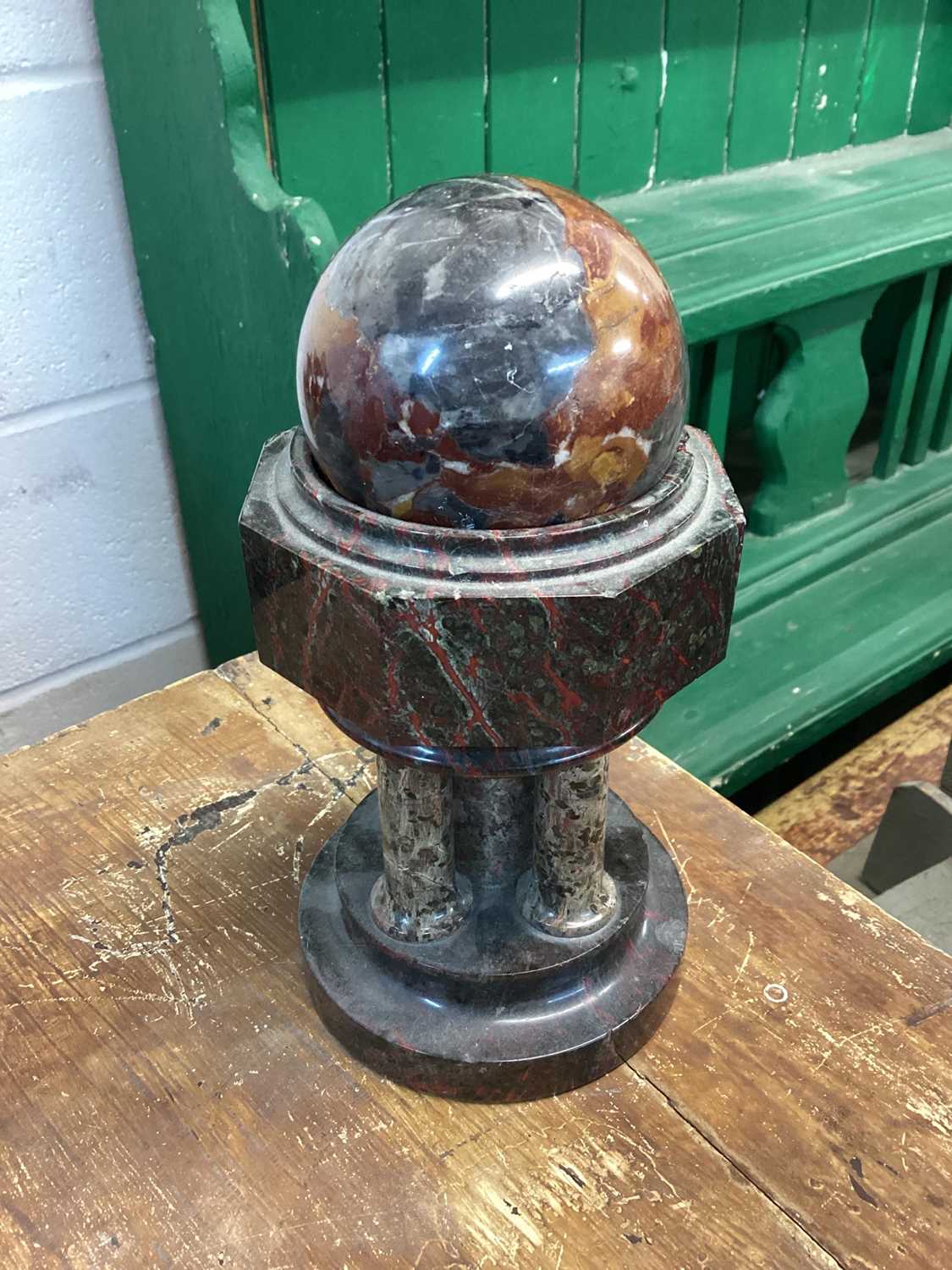 Lot 1596 - Turned marble sphere raised on a stand