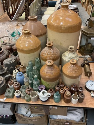 Lot 536 - Collection of stoneware bottles including some local interest, together with glass cod bottles and others.