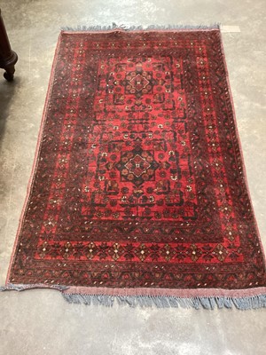 Lot 1379 - Eastern rug with geometric decoration on red ground, 158cm x 101cm