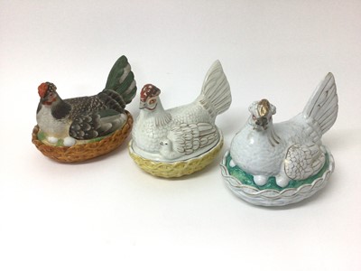 Lot 78 - Three 19th century pottery hens on nests, two sparsely decorated, the other with a well painted biscuit body, the largest 21cm across