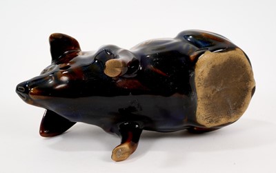 Lot 43 - Ewenny pottery model of a pig, the coin slot at the top, decorated with a mottled blue and brown glaze, with partly legible gilt inscription reading 'Born Aug 12-1908', 16.5cm length