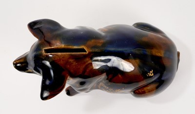 Lot 79 - Ewenny pottery model of a pig, the coin slot at the top, decorated with a mottled blue and brown glaze, with partly legible gilt inscription reading 'Born Aug 12-1908', 16.5cm length