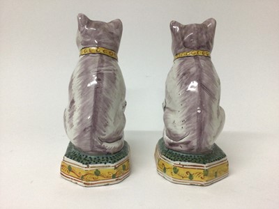 Lot 80 - Pair of Dutch delftware cats, 19th/20th century, modelled seated on octagonal bases, polychrome painted, with 'AK' marks to bases, 17.5cm high