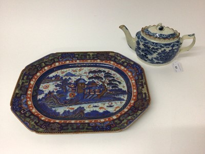 Lot 83 - 18th century Chinese blue and white export platter with later clobbered decoration, 40cm wide, and an early 19th century English pearlware glazed transfer printed teapot with swan finial (2)