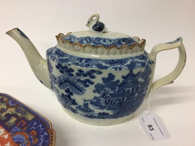 Lot 52 - 18th century Chinese blue and white export platter with later clobbered decoration, 40cm wide, and an early 19th century English pearlware glazed transfer printed teapot with swan finial (2)