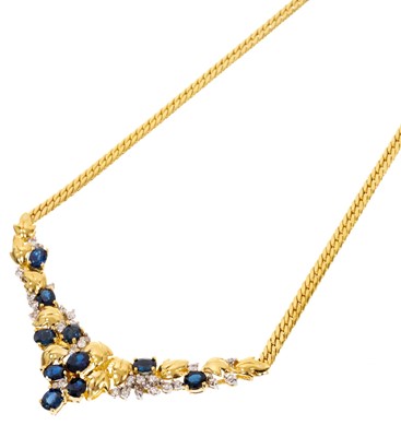 Lot 673 - Sapphire and diamond necklace with oval mixed cut blue sapphires and brilliant cut diamonds in floral and foliage design, in 18ct yellow gold setting.