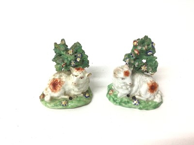 Lot 129 - Pair of Derby porcelain figures of recumbent sheep, circa 1800, with bocage, polychrome decorated