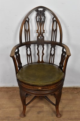 Lot 1317 - Gothic style mahogany revolving desk chair, with arched tracery back and circular saddle seat on cabriole legs