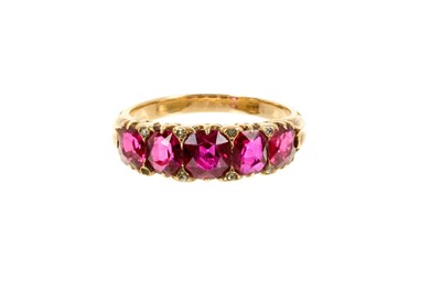 Lot 462 - Late Victorian ruby five stone ring with five graduated oval mixed cut rubies with diamond accents to the claw in 18ct gold setting