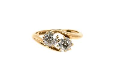 Lot 465 - Diamond two-stone ring with two old cut diamonds estimated to weigh approximately 0.60cts each, in gold crossover setting. Estimated total diamond weight approximately 1.2cts.