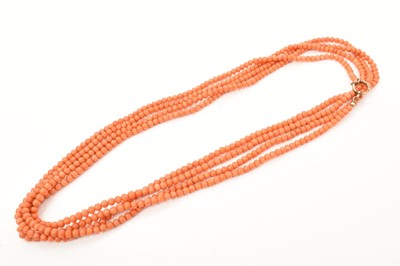 Lot 477 - Antique coral long chain/guard chain with a long string of coral beads on gilt metal clasp.