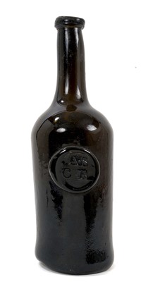 Lot 1637 - Mid 18th century sealed glass wine bottle, the seal initialled for All Souls Common Room, 28cm high, with accompanying note stating 'bought by the poet Anthony Thwaite following a discussion he had...